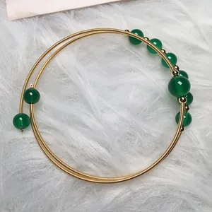 Close-up of 14K gold filled wire wrapped green agate double layered bangle