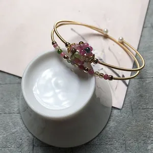 Detail of 14K gold-filled wire-wrapped bracelet with tourmaline beads and white pearls