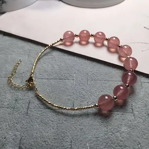 Pink strawberry crystal beaded bracelet with 14K gold-plated twisted bar and lobster clasp