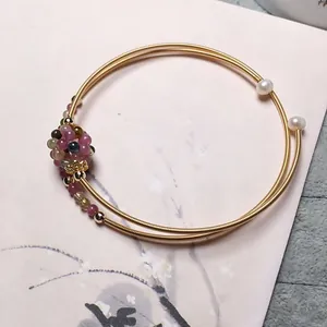 Detail of 14K gold filled double coil bracelet with pearls and colorful gemstone cluster