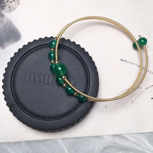 Detail of 14K gold-filled wire-wrapped bracelet with translucent green agate beads
