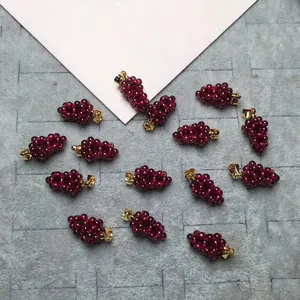 Macro shot of garnet grape pendants with 14K gold-filled clasps for DIY jewelry