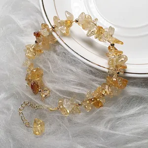 Citrine gemstone bead bracelet with 14K gold plated clasp on a white ceramic plate