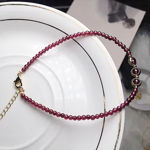 Detailed macro view of wine red garnet bead bracelet with 14K gold-filled lobster clasp