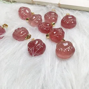 Macro detail of cat paw shaped strawberry quartz pendants on soft white faux fur