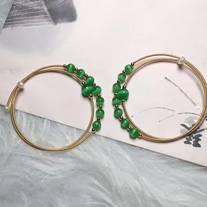 Detail of 14K gold filled multi-layer cat eye stone bracelet with green beads and pearls