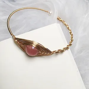 Detail of 14K gold wire wrapped strawberry quartz bracelet with pearl accent