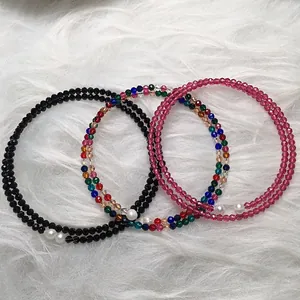 Close-up of double-layer faceted 3mm spinel bracelets in black, rose red, and rainbow colors