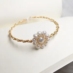 Handmade 14K wire-wrapped freshwater pearl bracelet with a floral center design