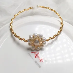 Detail of 14K gold wire hand-wrapped freshwater pearl bracelet with floral cluster