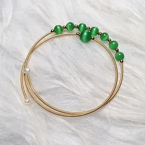 Detail of 14K gold-filled multi-layer coil bracelet with green opal beads and pearls