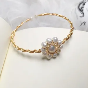Detail of 14K gold-wrapped wire bracelet with freshwater pearls in flower design
