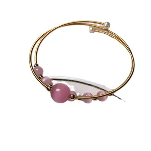 Elegant 14K gold-filled double bangle with pink cat-eye stones and white pearls
