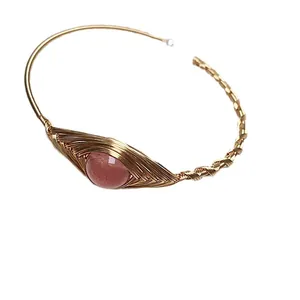 Handcrafted 14K gold wire wrapped strawberry quartz bangle with intricate woven design