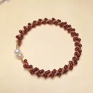 Detailed macro shot of garnet bead bracelet with 14K gold-filled accents and pearls