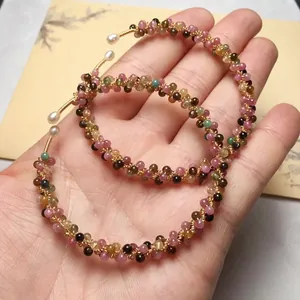 Close-up of handmade 14K gold-filled wire bracelet with colorful tourmaline beads and pearls