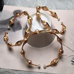 Detailed macro view of handmade 14K gold wire wrapped freshwater pearl bracelet