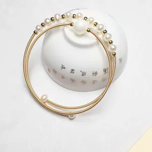 Detail of 14K gold filled double-layer wire bracelet with round freshwater pearls