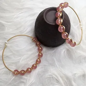 Handcrafted strawberry quartz bangle with 14K gold filled wire wrapping and pearls