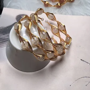 Detailed macro view of handmade gold wire-wrapped bracelets with natural stone beads
