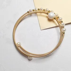 Multi-layer gold-plated spiral wire bracelet with freshwater pearls and metallic beads