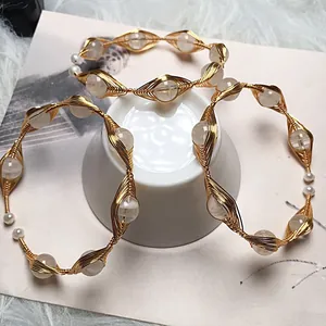 Detail of 14K gold wire wrapped bracelets with crystal beads and freshwater pearls