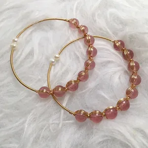 Detail of strawberry crystal bracelet with 14K gold wire wrapping and small pearls