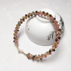 Detail of colorful tourmaline beads and pearls with handcrafted 14K gold-filled wire weave