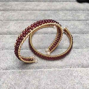Elegant 14K gold-wrapped garnet beaded spiral bangle with white pearl accents