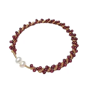 Garnet beaded bracelet with 14K gold-filled accents and two white pearls on white background