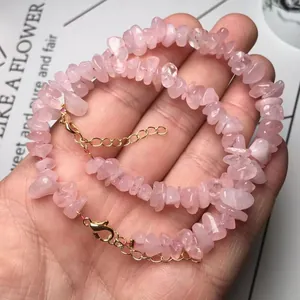 Detailed shot of pink quartz chip bracelet with gold lobster clasp and extension chain