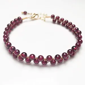 Detail of garnet beaded bracelet with 14K gold filled wire wrap and lobster clasp