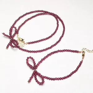 Garnet beaded necklace and bracelet set with bow charm and gold lobster clasp