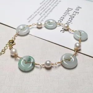 Detailed view of freshwater pearl and jadeite donut bracelet with 14K gold lobster clasp