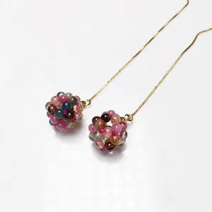 Detail of colorful tourmaline bead cluster earrings with elegant gold chain links