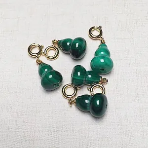 Malachite gourd charms with gold spring clasps showing natural green stone texture