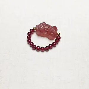 Garnet beaded ring with pink strawberry crystal Pi Xiu and golden metallic accents