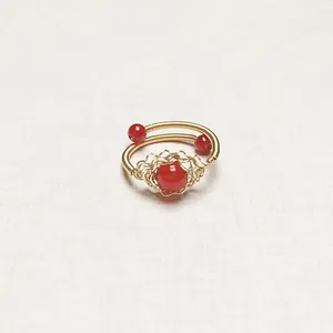Detailed macro view of handmade 14K gold filled wire wrapped red agate stone ring
