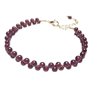 Elegant garnet beaded bracelet with 14K gold-filled lobster clasp on white background