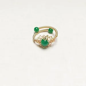 Handmade 14K gold wire wrapped ring featuring green agate beads on linen background