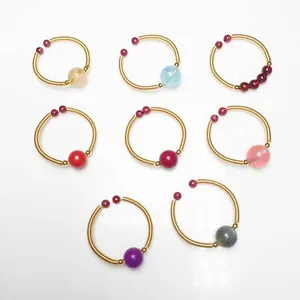 Detail of 14K gold wire wrapped rings featuring multi-color natural gemstone beads