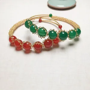 Detail of red and green agate beads with handcrafted 14K gold-filled wire weaving
