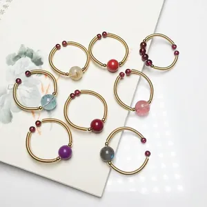 Detail of 14K gold wire wrapped rings with various natural round gemstone beads