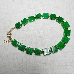 Detailed macro of green clover beads with gold spacers and 14K gold lobster clasp