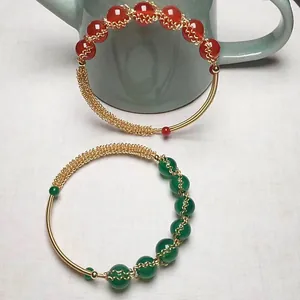 Detail of red and green agate beads with 14K gold-filled wire wrapped craftsmanship