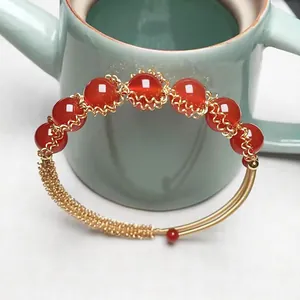 Detailed view of red agate beaded bracelet with 14K gold-filled wire wrap design