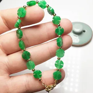 Close-up of green chalcedony four-leaf clover bracelet with 14K gold-filled beads