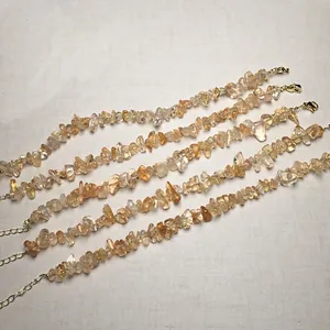 Detailed view of five adjustable gemstone bracelets with yellow citrine and gold clasps