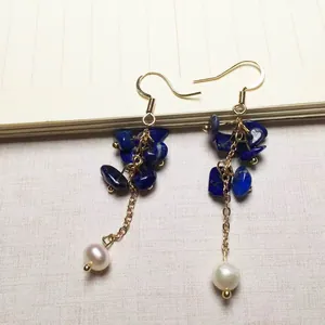 Detailansicht der handgefertigten Gold-Ohrhaken mit Lapislazuli-Steinen und Süßwasserperle