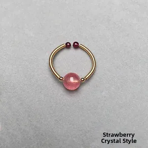 Detail showing hand-wrapped gold wire ring with strawberry quartz and iced textures